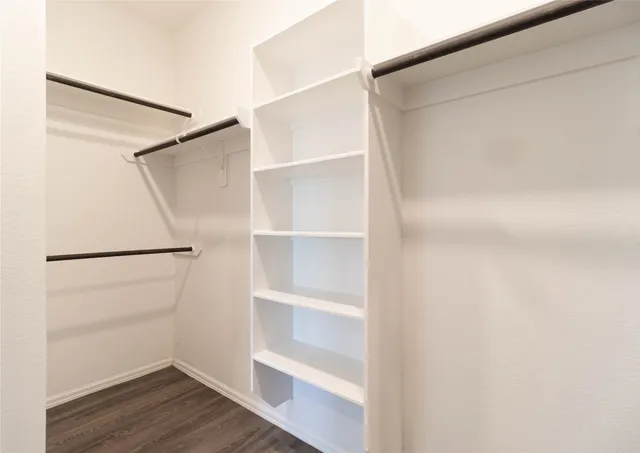 a view of an empty walk in closet with empty racks