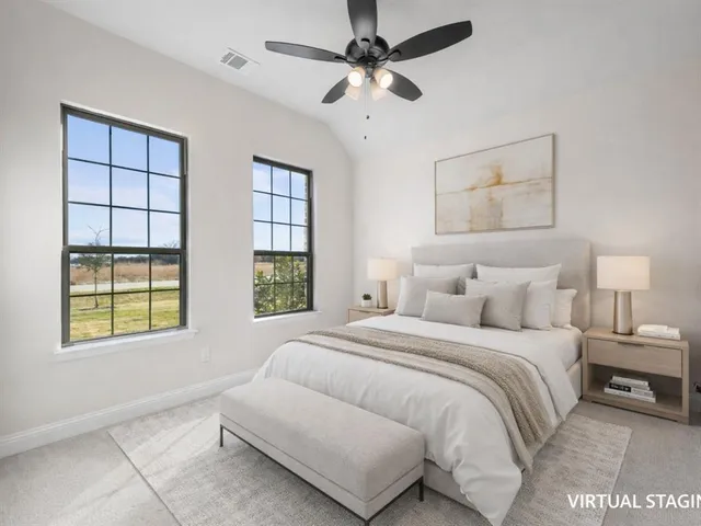 an empty room with a window and a ceiling fan