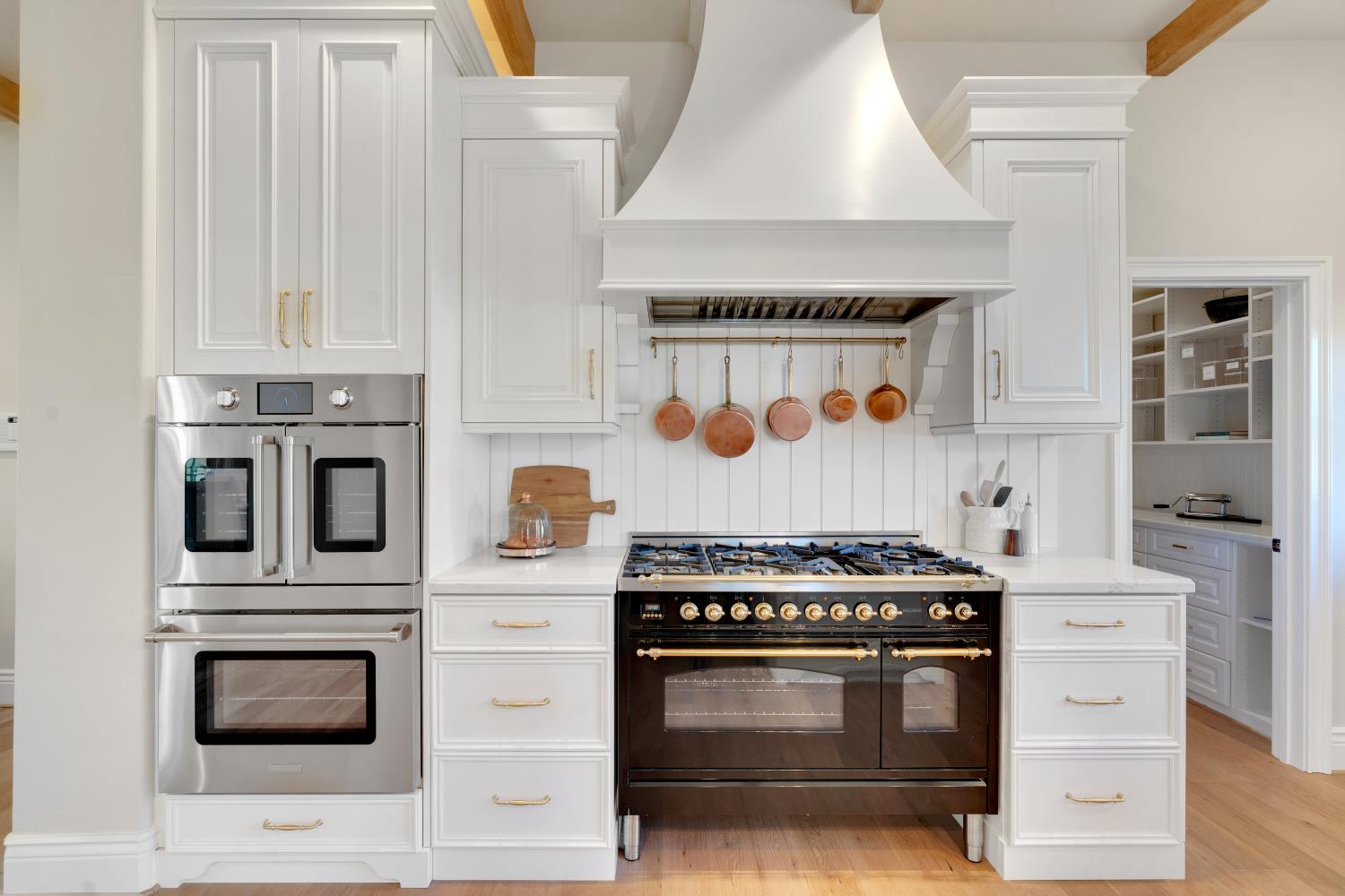 2905 Virginiatown Road Lincoln, CA 95648 - Photo 15 of 86 Gourmet kitchen featuring a built-in double oven, professional-grade range with a custom hood, white cabinetry, a large walk-in pantry, and wood-finish flooring
