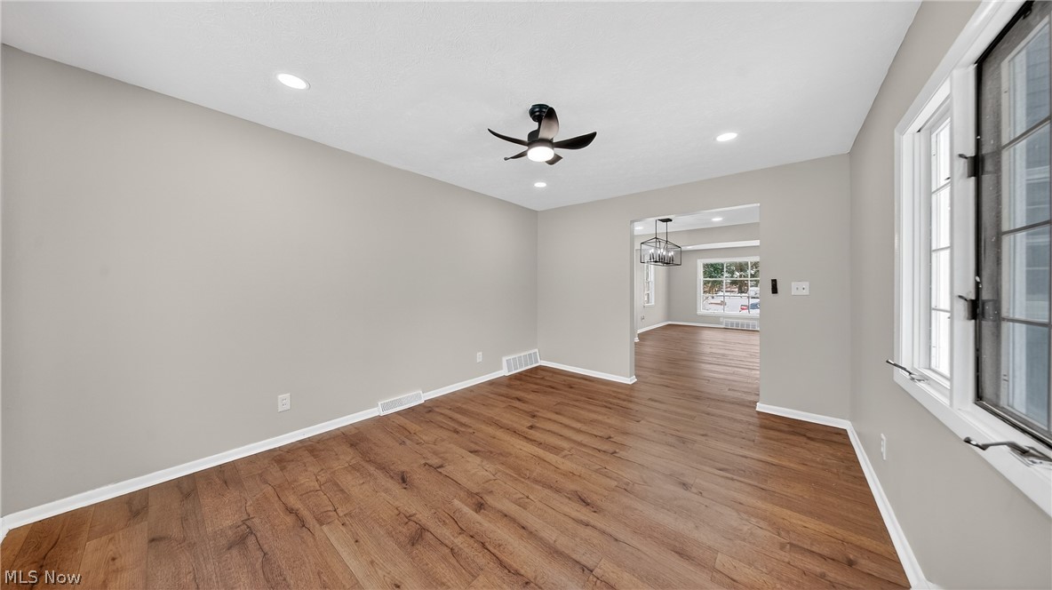 16811 Invermere Avenue Cleveland, OH 44128 - Photo 22 of 47 Spare room featuring recessed lighting, wood finished floors, a ceiling fan, and a chandelier