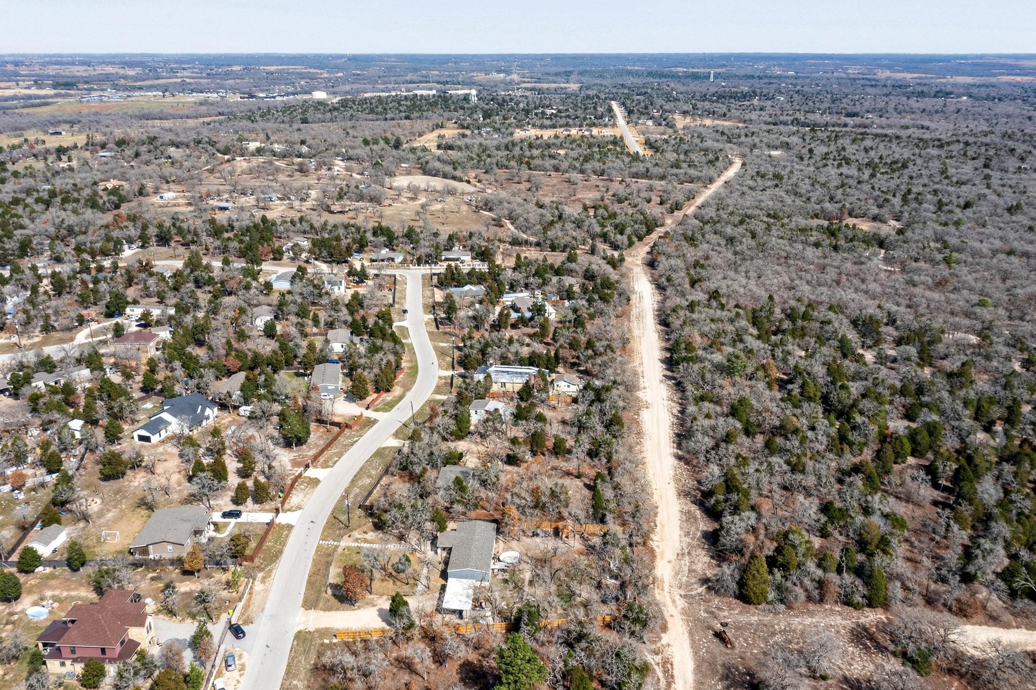 147 Jasmine Heights Elgin, TX 78621 - Photo 8 of 22 an aerial view of house with yard and mountain view in back