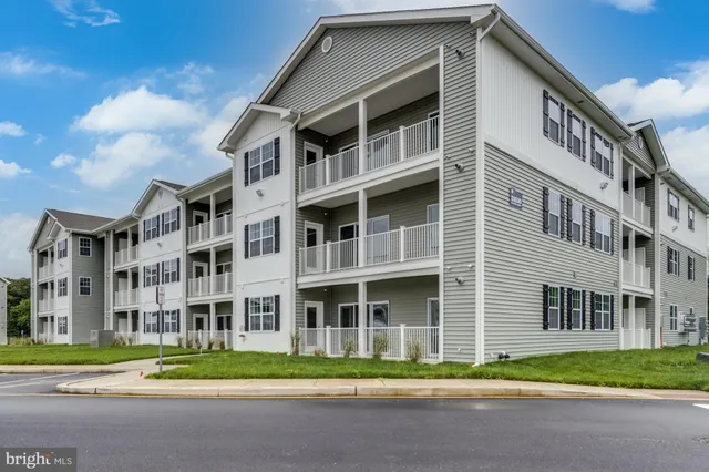 a front view of a building with a yard