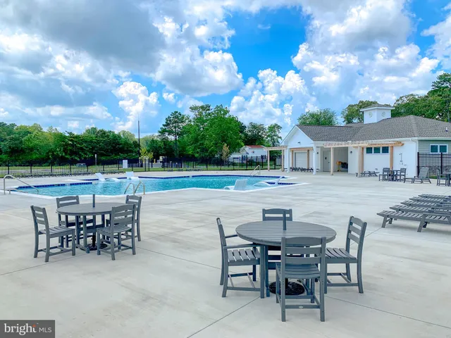 a view of a patio with table and chairs