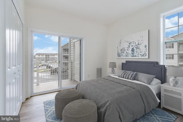 a bedroom with furniture and a large window