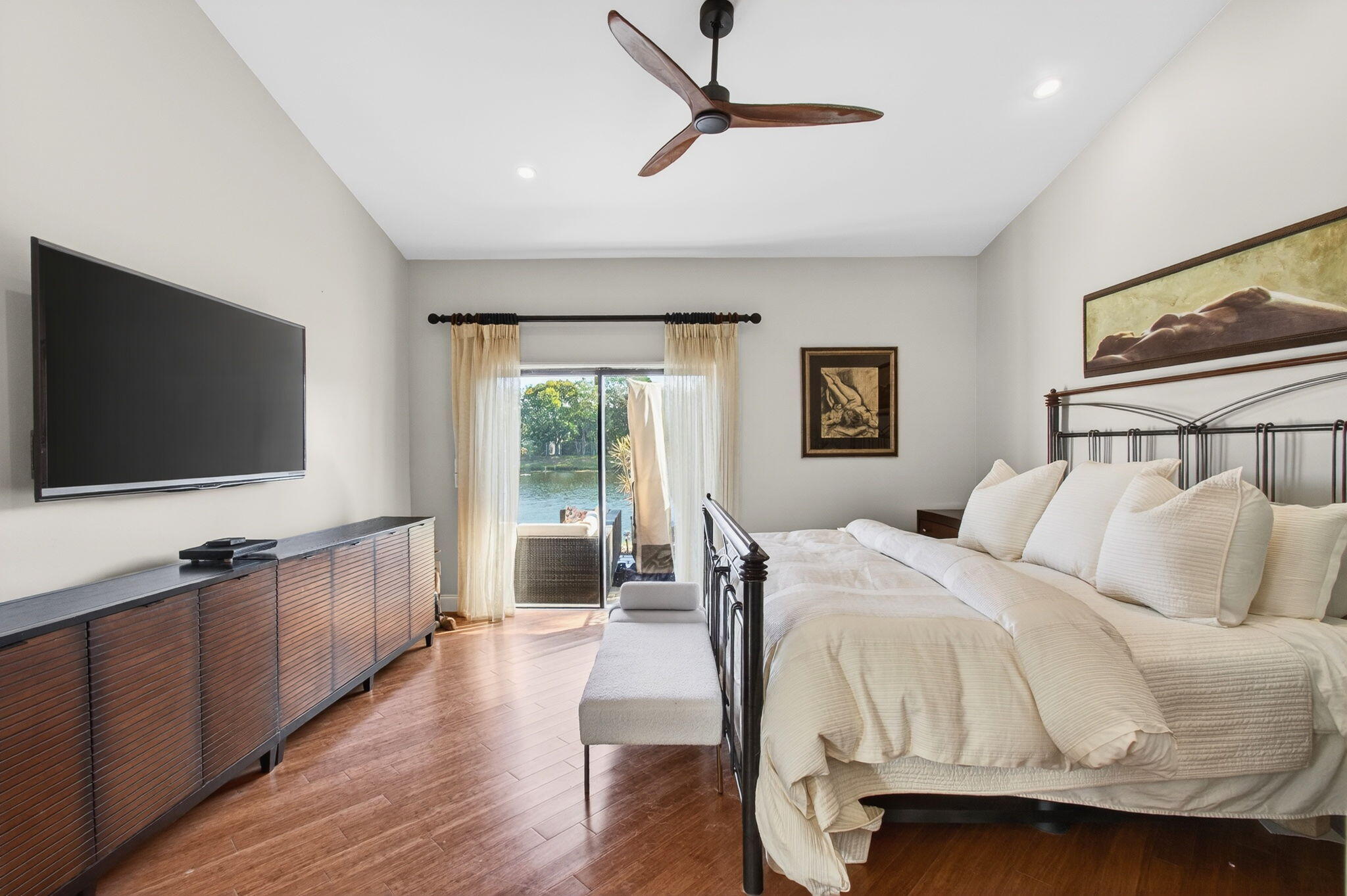 23145 Via Stel Boca Raton, FL 33433 - Photo 26 of 72 a bedroom with a bed and a flat screen tv on dresser