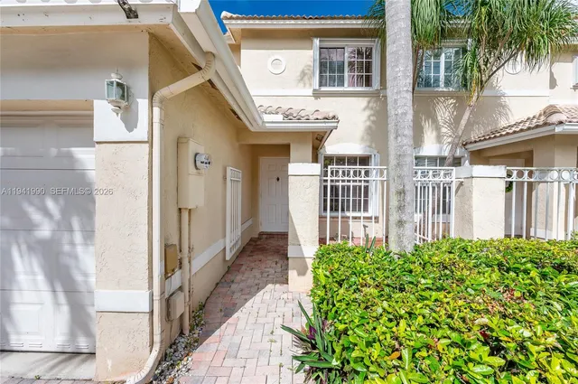 a view of a brick house with a small yard