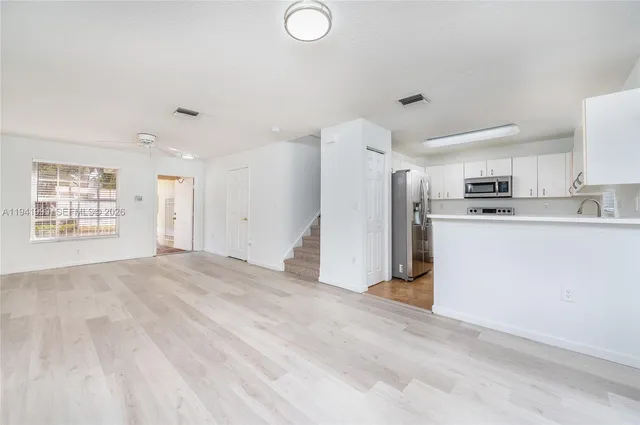 a view of a kitchen with a sink cabinets and a window
