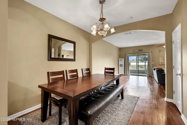 a view of a dining room with furniture and wooden floor