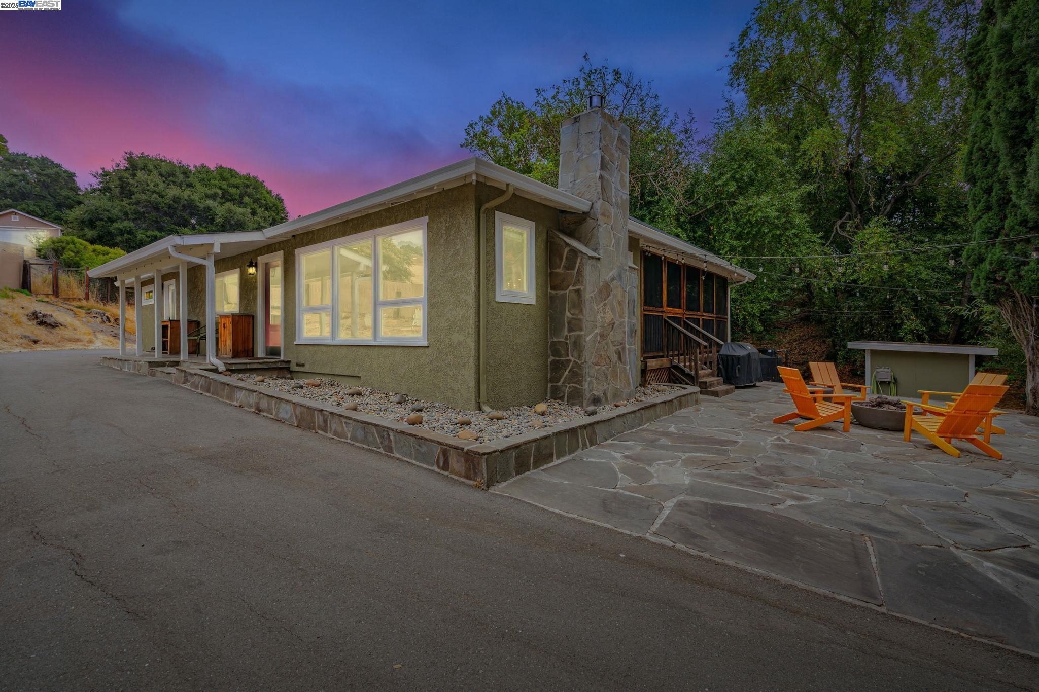 a backyard of a house with table and chairs