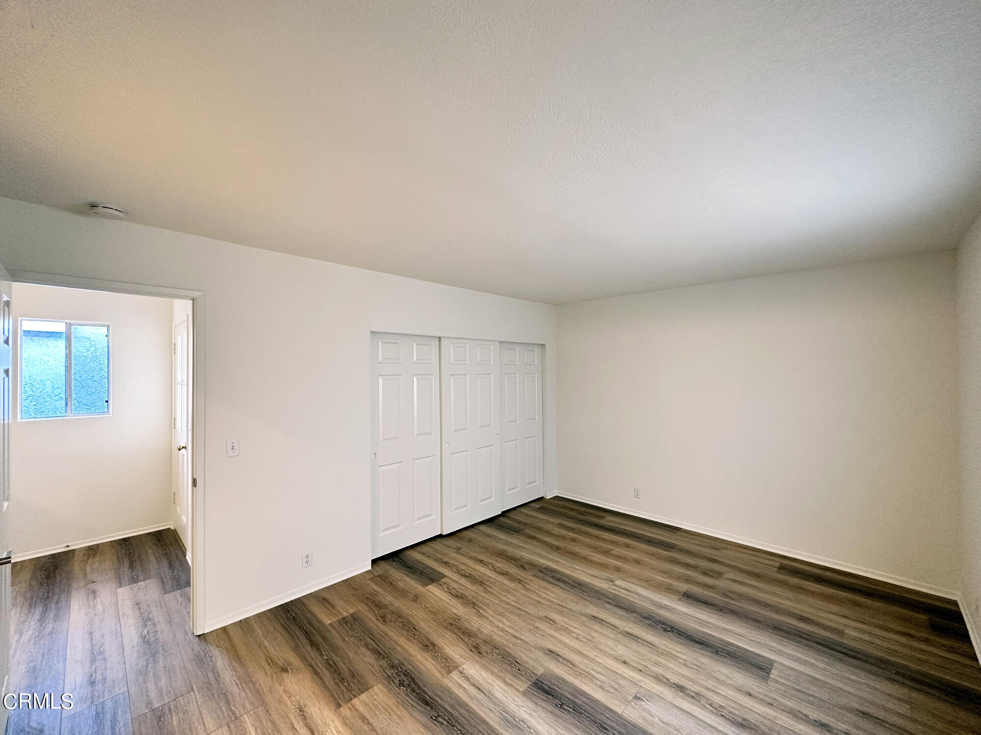 356 Highland Drive Oxnard, CA 93035 - Photo 15 of 26 a view of a room with wooden floor and white walls