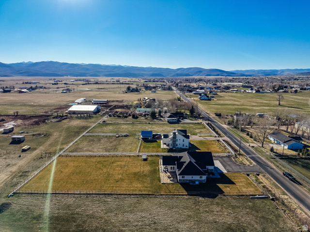 352 East Boulderville Road Oakley, UT 84055 - Photo 57 of 62 Aerial view of property and surrounding area featuring a mountainous background and rural landscape