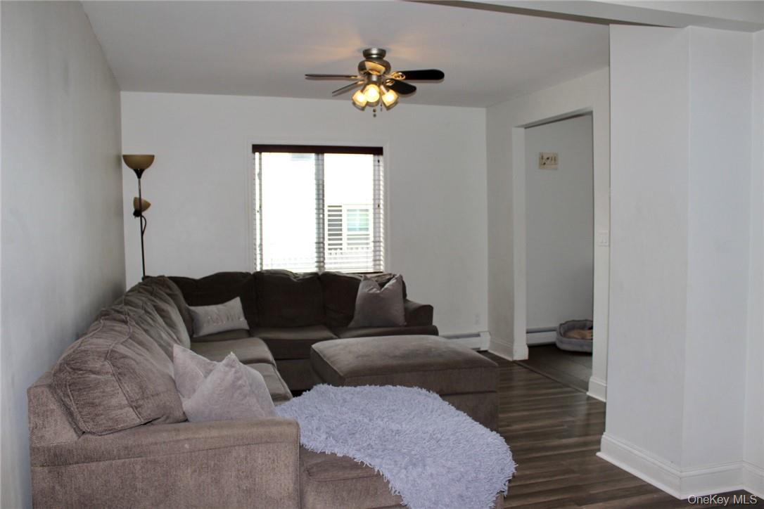 5834 Albany Post Road Cortlandt Manor, NY 10567 - Photo 5 of 14 Living room with ceiling fan, baseboard heating, and dark hardwood / wood-style floors