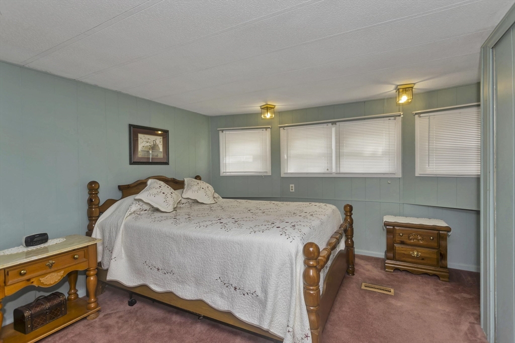 32 Puffin Drive Chicopee, MA 01020 - Photo 13 of 25 a bedroom with a bed and a washing machine in it