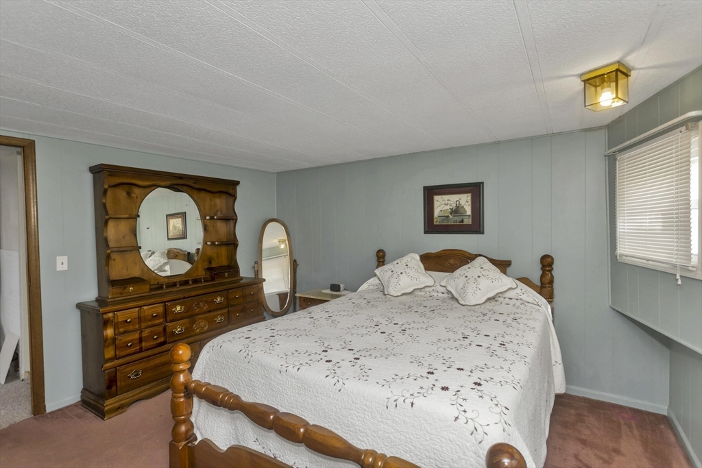 32 Puffin Drive Chicopee, MA 01020 - Photo 15 of 25 a bedroom with a bed and a dresser in it