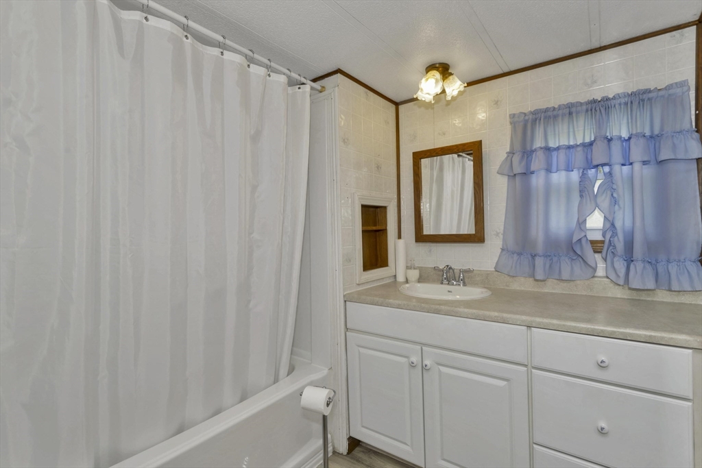 32 Puffin Drive Chicopee, MA 01020 - Photo 16 of 25 a bathroom with a sink and a mirror