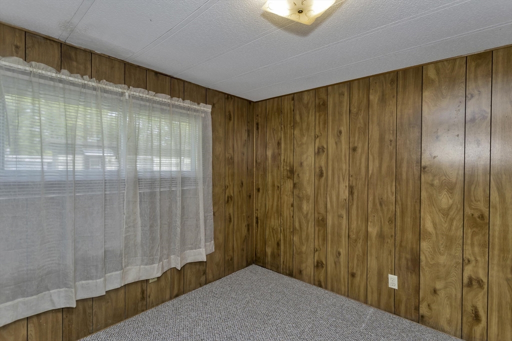 32 Puffin Drive Chicopee, MA 01020 - Photo 18 of 25 a view of a big room with wooden floor and windows