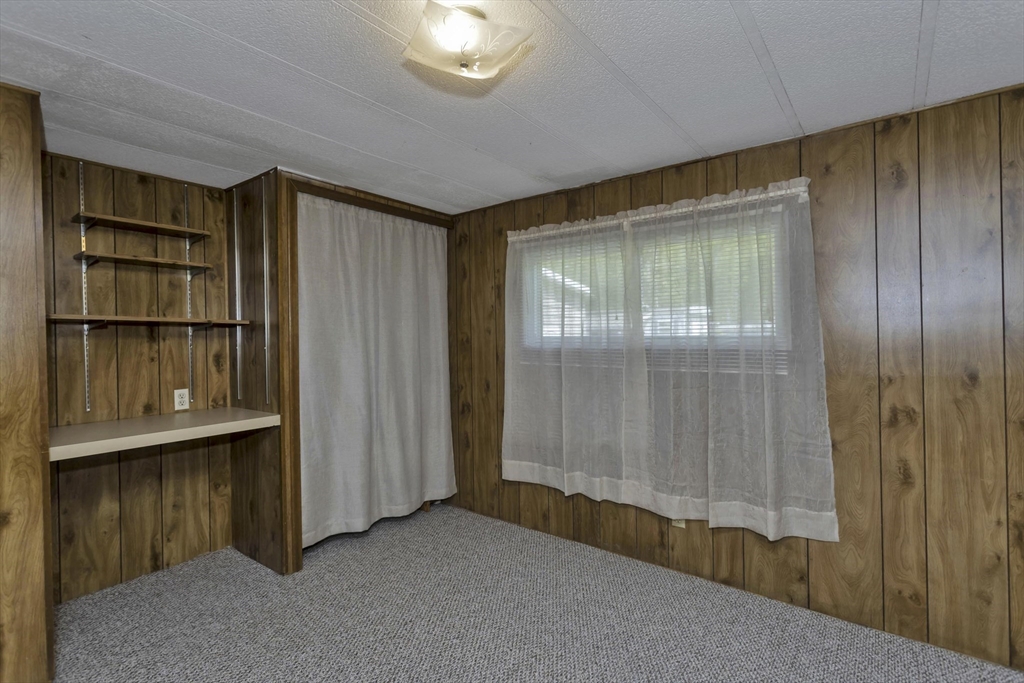 32 Puffin Drive Chicopee, MA 01020 - Photo 19 of 25 a view of an empty room with a fireplace and cabinet