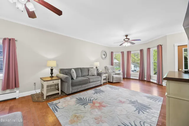 a living room with furniture and a chandelier