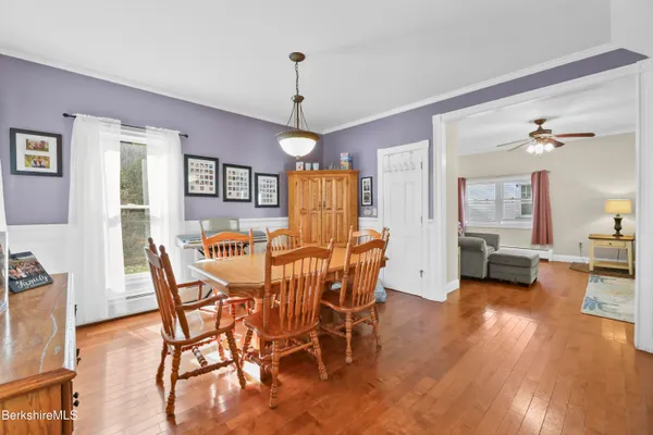 a view of a dining room with furniture window and wooden floor