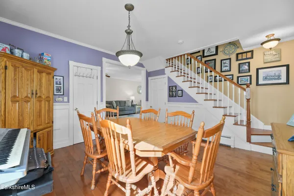 a view of a dining room with furniture and a chandelier