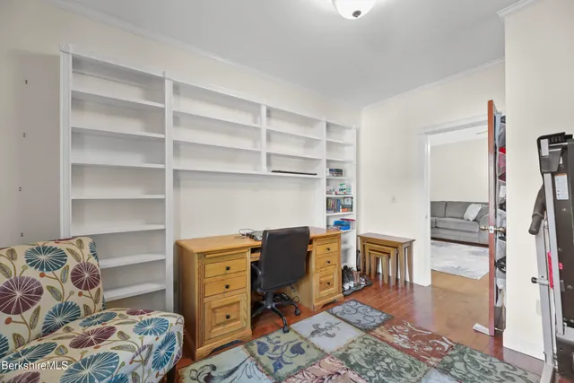 a view of a bedroom with workspace and bedroom