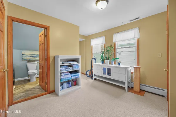 a bedroom with furniture and a window