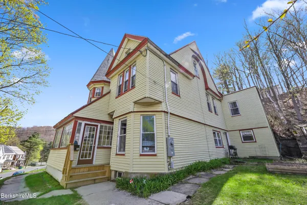 a front view of a house with a garden