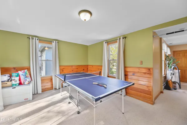 a room with pool table and large windows