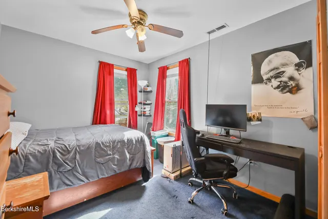 a bedroom with a bed and a desk