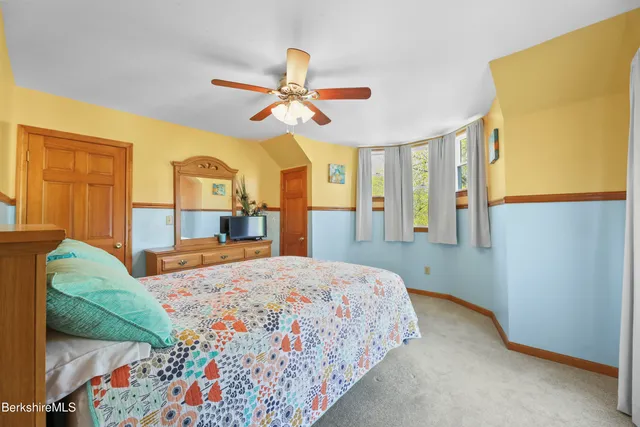 a bedroom with a bed dresser and a window