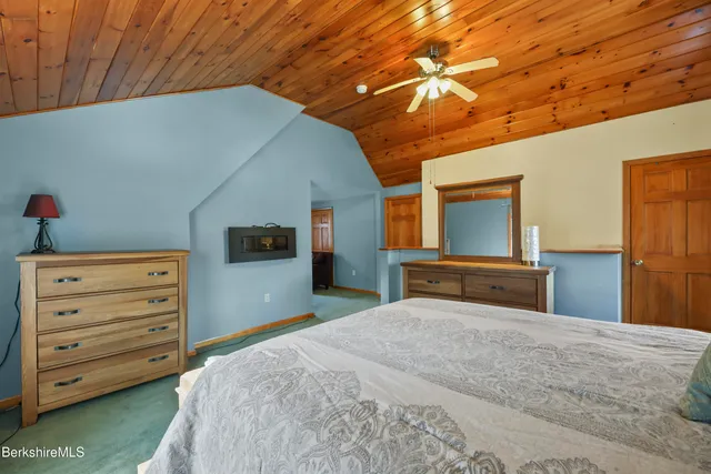 a bedroom with a bed and a bookshelf