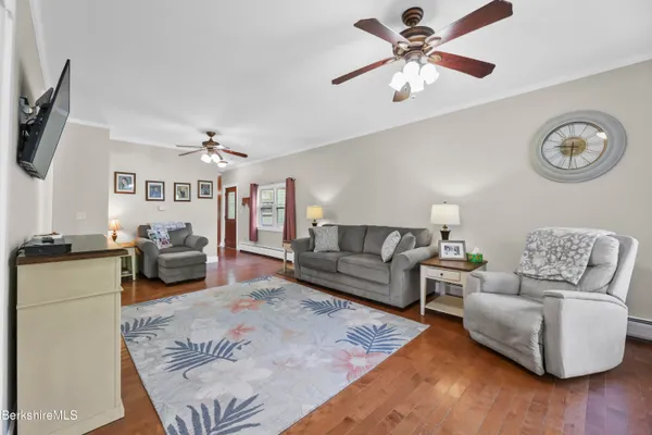 a living room with furniture and a chandelier
