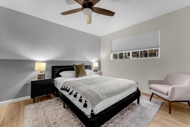 a bedroom with a bed and a chandelier