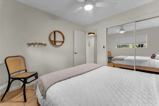an workspace room with wooden floor mirror and outdoor view