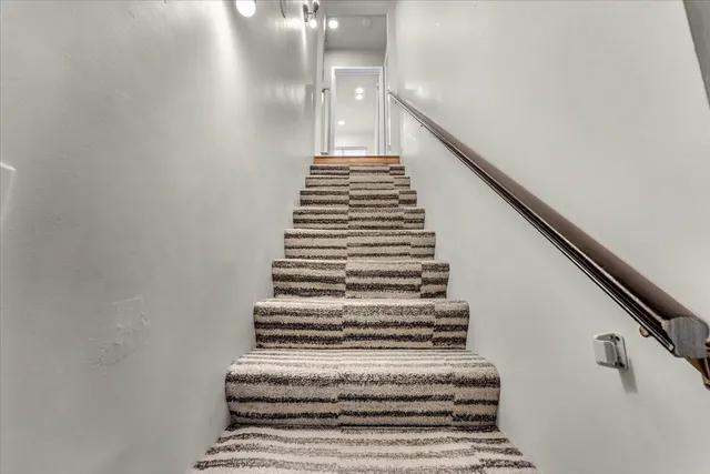 a bedroom with furniture and a flat screen tv