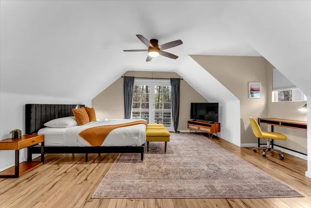 a bedroom with a bed and wooden floor