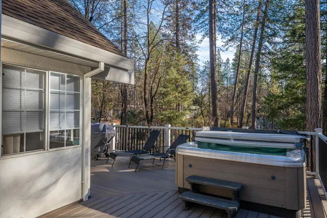 a view of backyard with a deck and wooden floor
