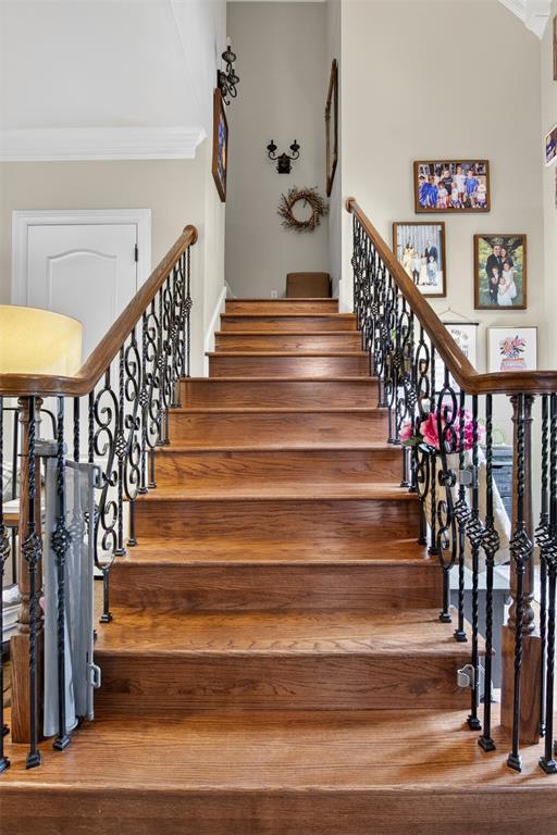11868 Timber Ridge Drive Keithville, LA 71047 - Photo 20 of 37 Wood-finish staircase featuring decorative wrought iron balusters and a polished wood handrail