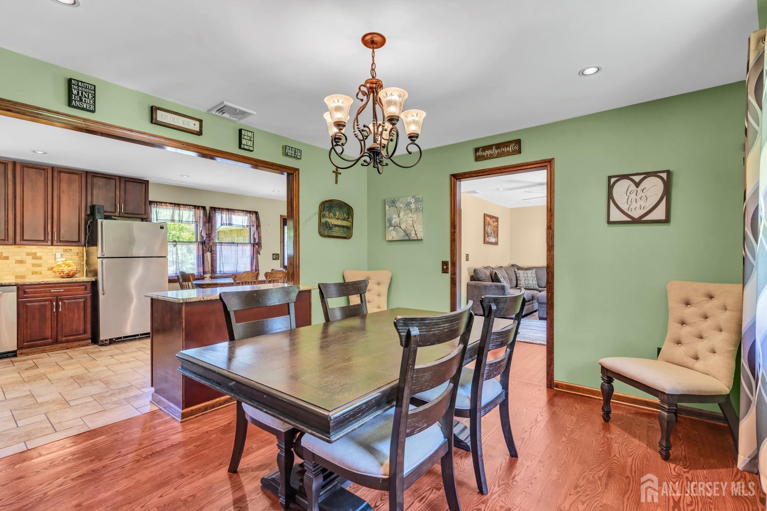 99 Schulmeister Road Old Bridge, NJ 08857 - Photo 10 of 49 a view of a dining room with furniture a chandelier and wooden floor