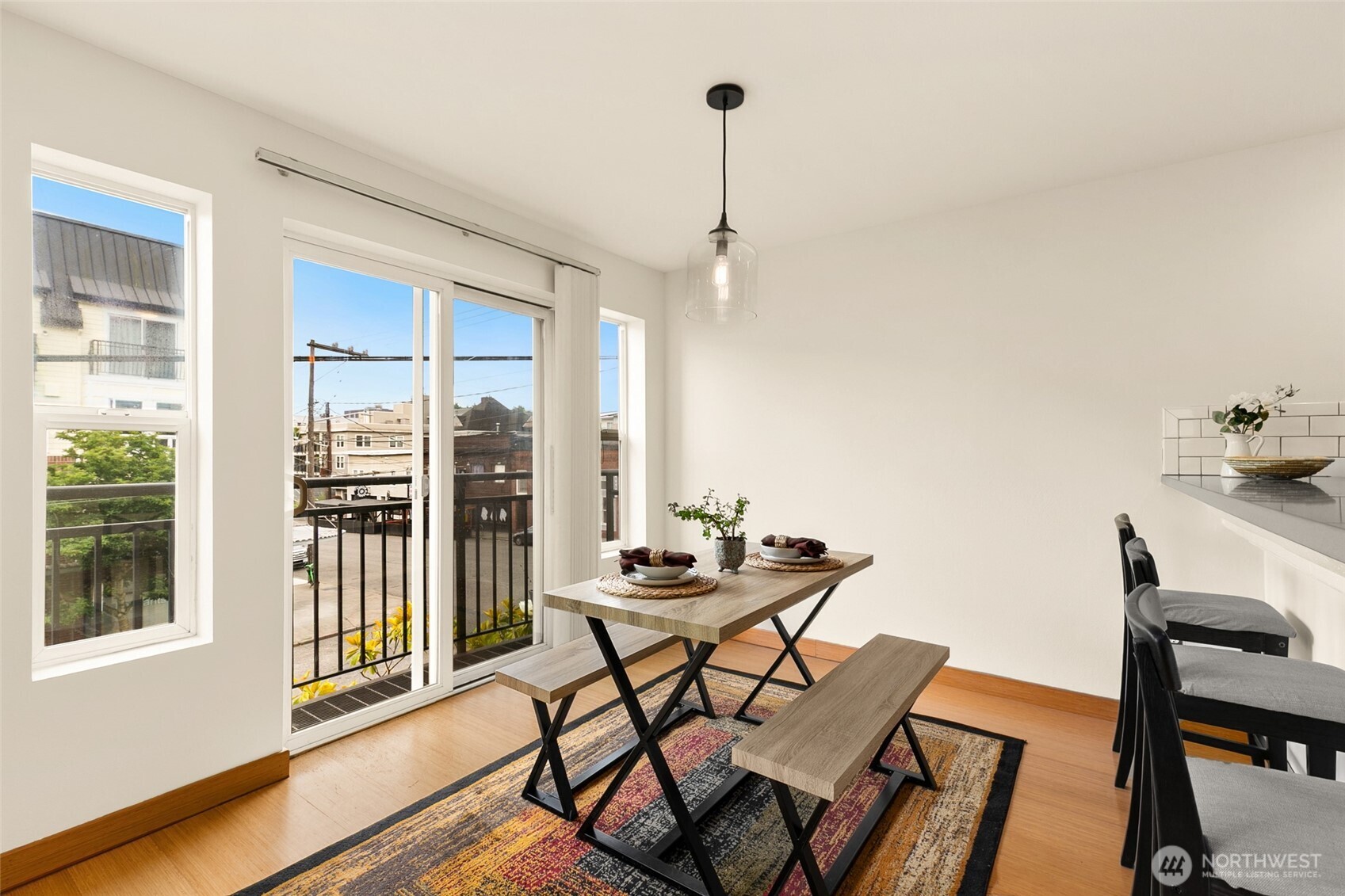 500 Aloha Street, Unit 202 Seattle, WA 98109 - Photo 4 of 15 a dining room with furniture a chandelier and wooden floor
