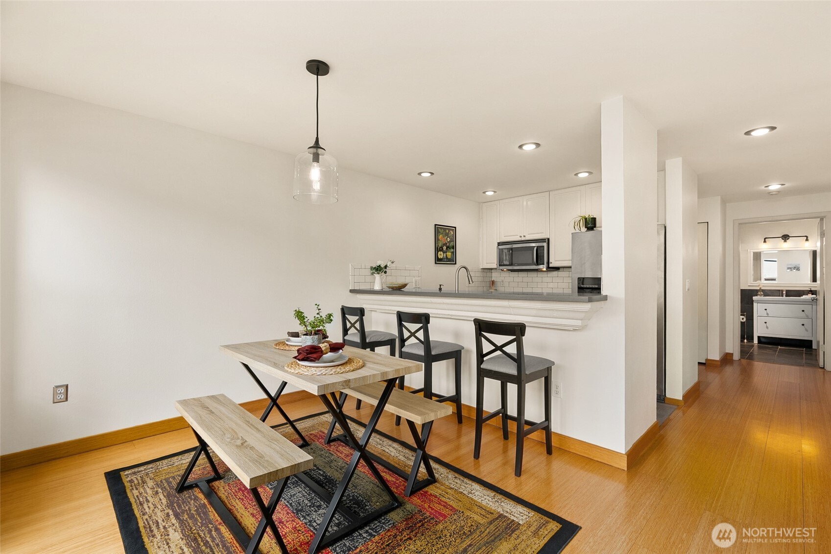 500 Aloha Street, Unit 202 Seattle, WA 98109 - Photo 5 of 15 a dining room with furniture and kitchen view