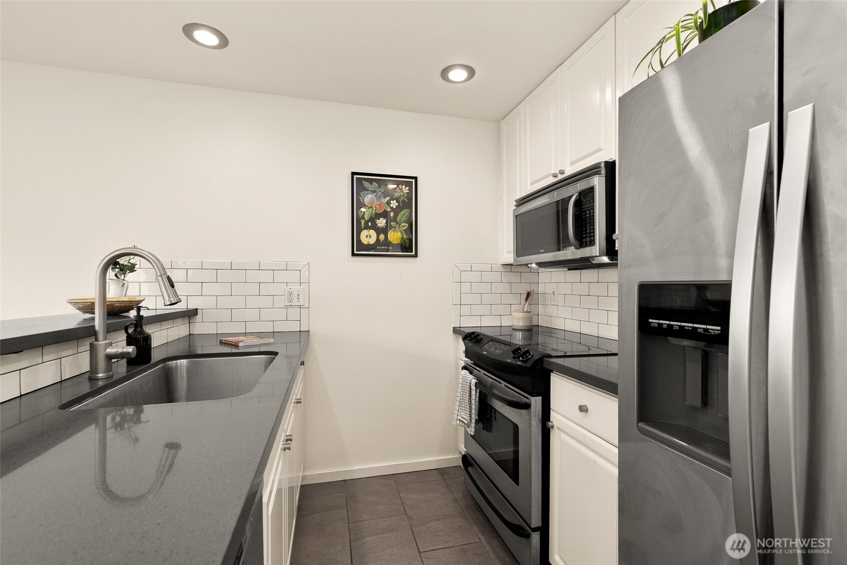 500 Aloha Street, Unit 202 Seattle, WA 98109 - Photo 7 of 15 a kitchen with a sink cabinets and stainless steel appliances