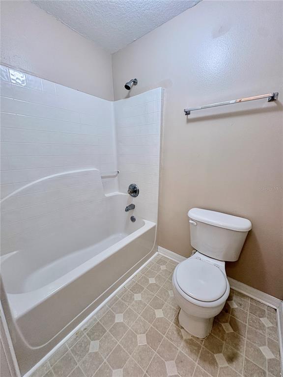 12007 Peach Avenue Seffner, FL 33584 - Photo 12 of 14 a bathroom with a toilet and a bathtub