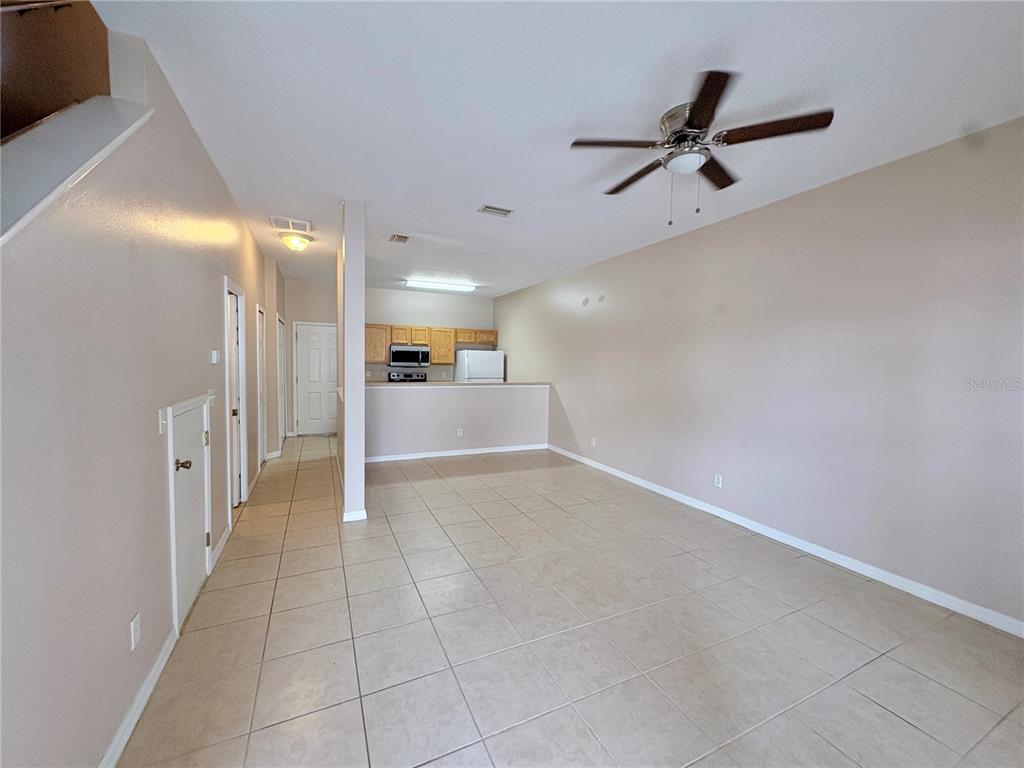 12007 Peach Avenue Seffner, FL 33584 - Photo 2 of 14 a view of a livingroom with a ceiling fan & entryway