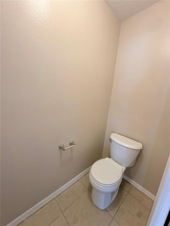 12007 Peach Avenue Seffner, FL 33584 - Photo 7 of 14 a white toilet sitting next to a white wall