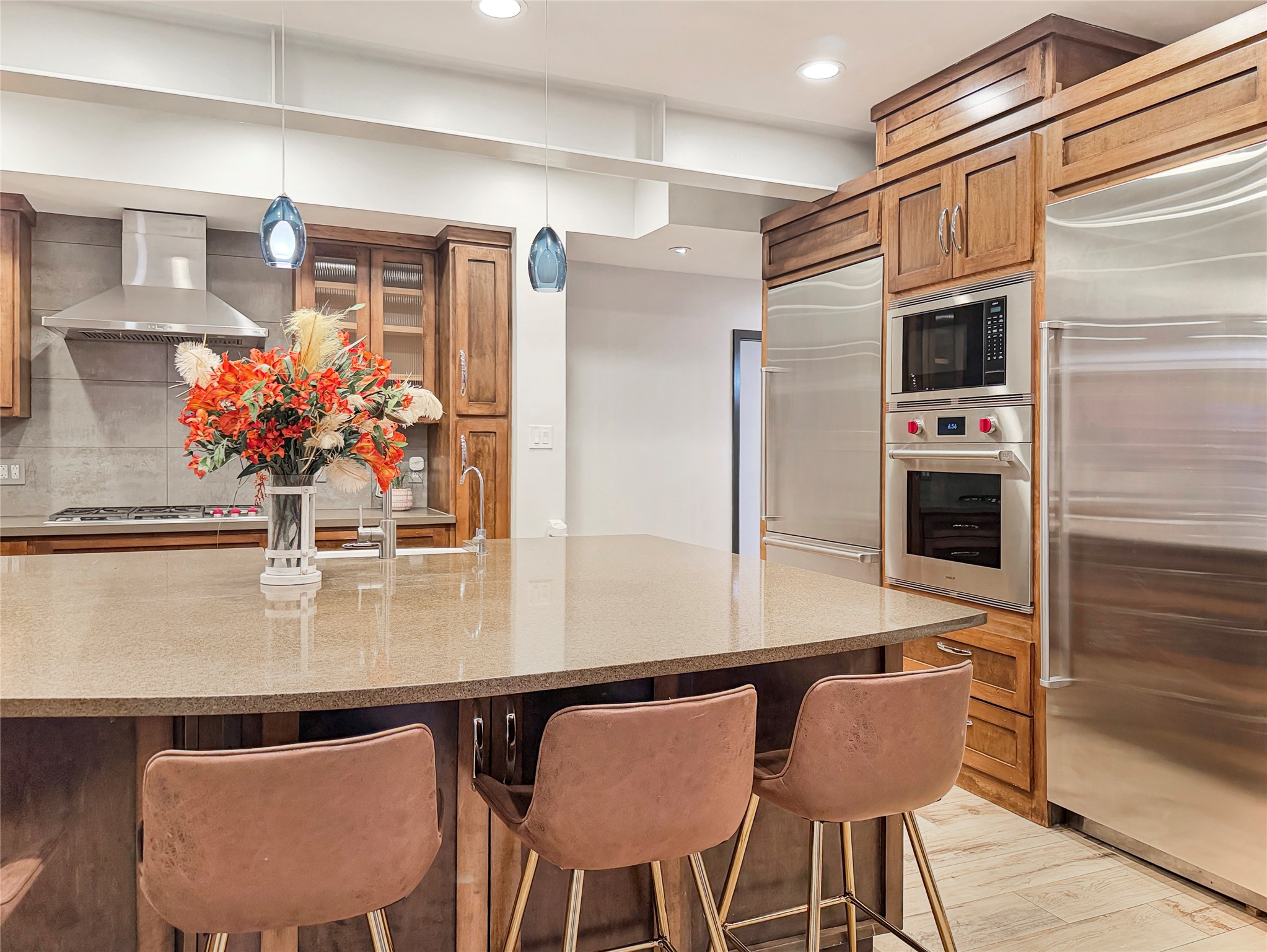 4521 Maple Street Bellaire, TX 77401 - Photo 13 of 36 Equipped with premium Wolf appliances, including a gas cooktop and wall oven, plus a full-size Sub-Zero refrigerator and separate Sub-Zero freezer for maximum storage and performance.
