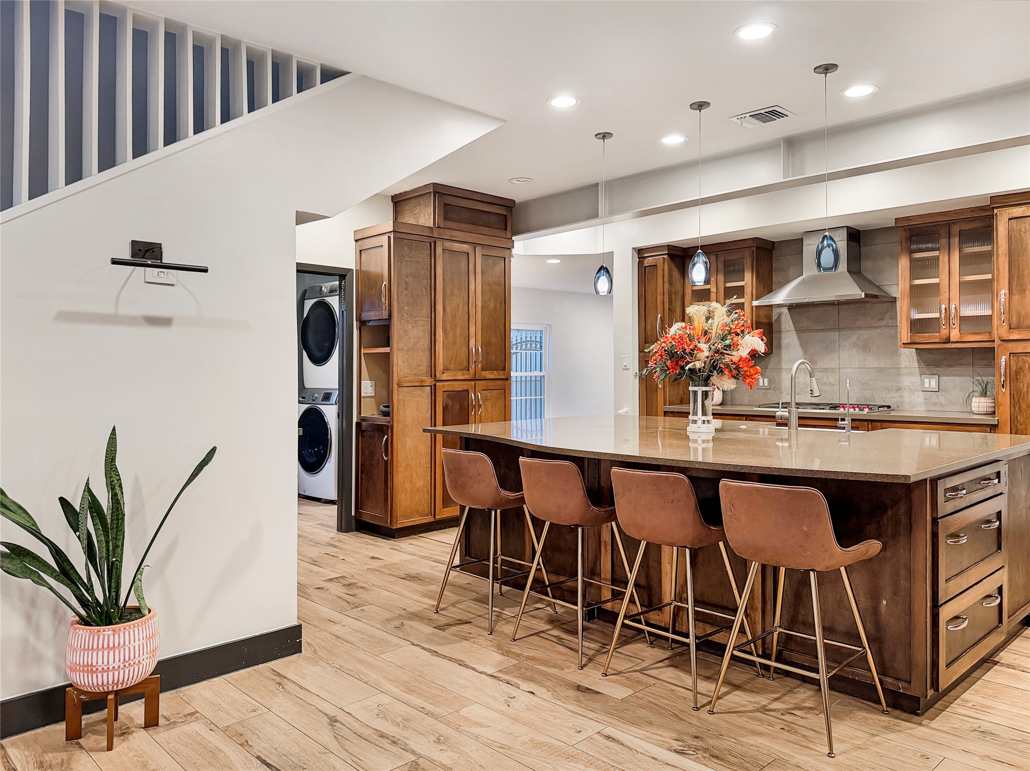 4521 Maple Street Bellaire, TX 77401 - Photo 14 of 36 Large central island with bar seating and farmhouse sink, offering a natural gathering space at the heart of the home.