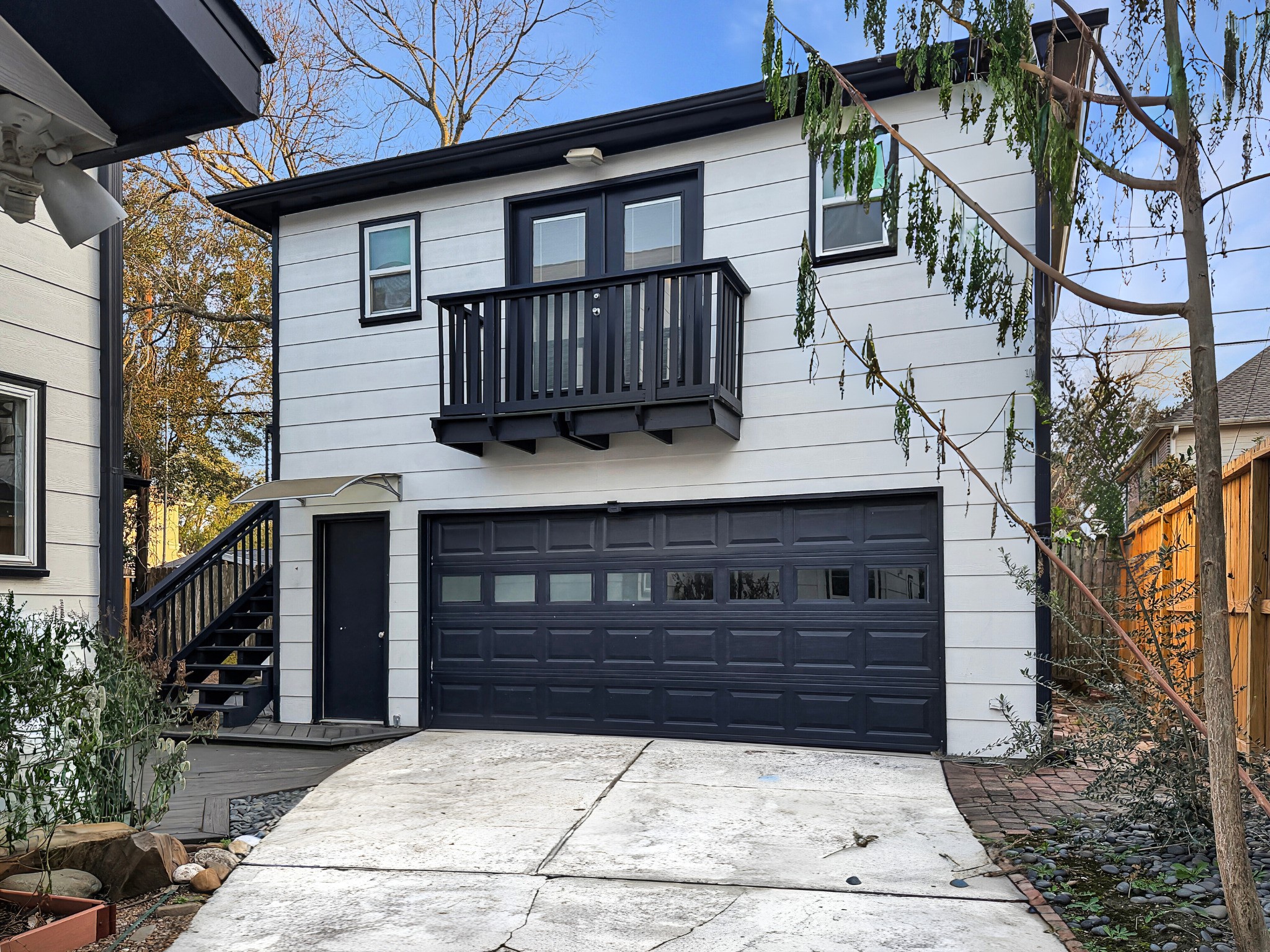 4521 Maple Street Bellaire, TX 77401 - Photo 28 of 36 Spacious two-car garage with upper-level garage apartment featuring a private balcony.