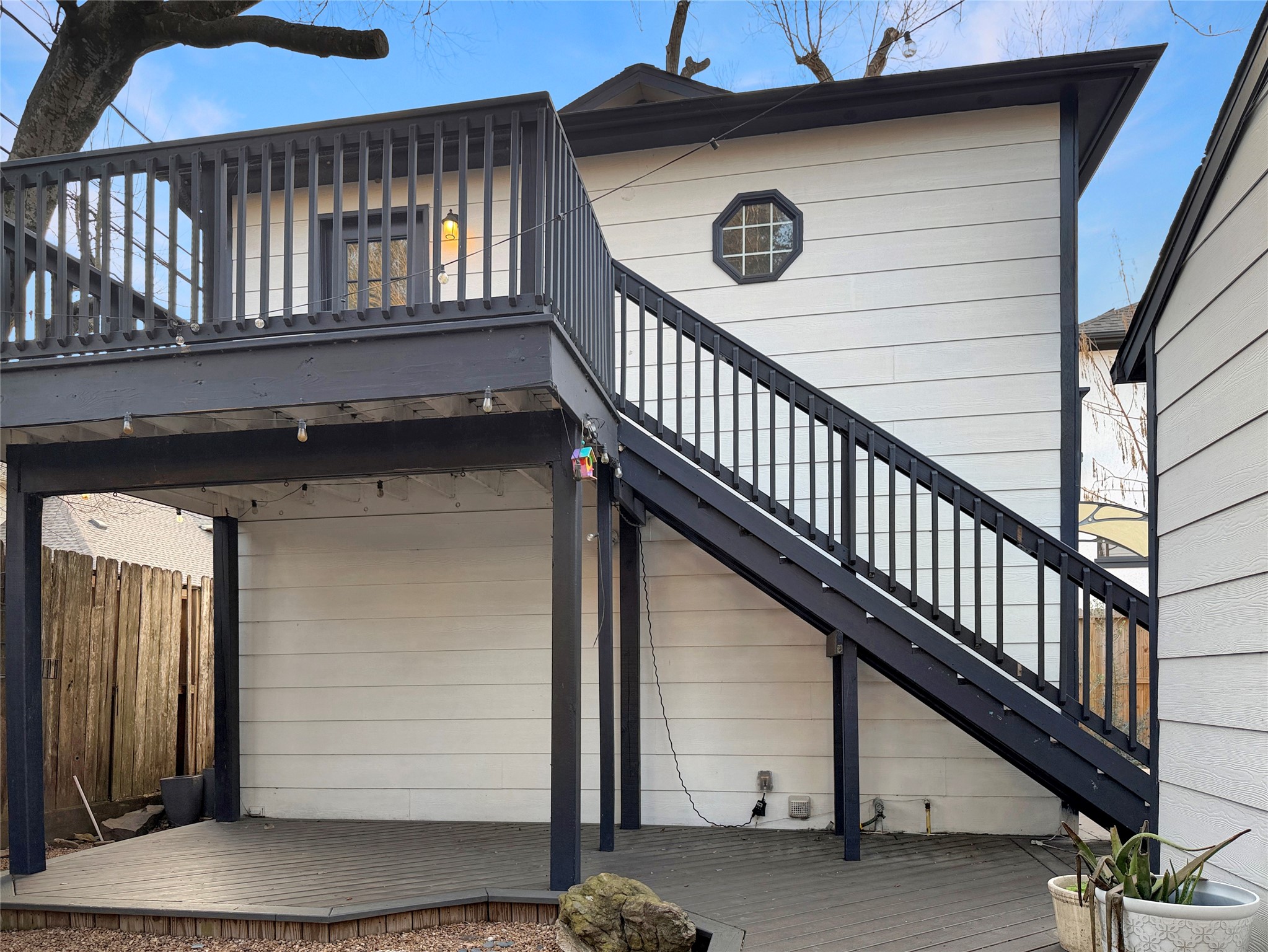 4521 Maple Street Bellaire, TX 77401 - Photo 29 of 36 Upper-level garage apartment with private balcony and covered patio area beneath, perfect for outdoor seating.