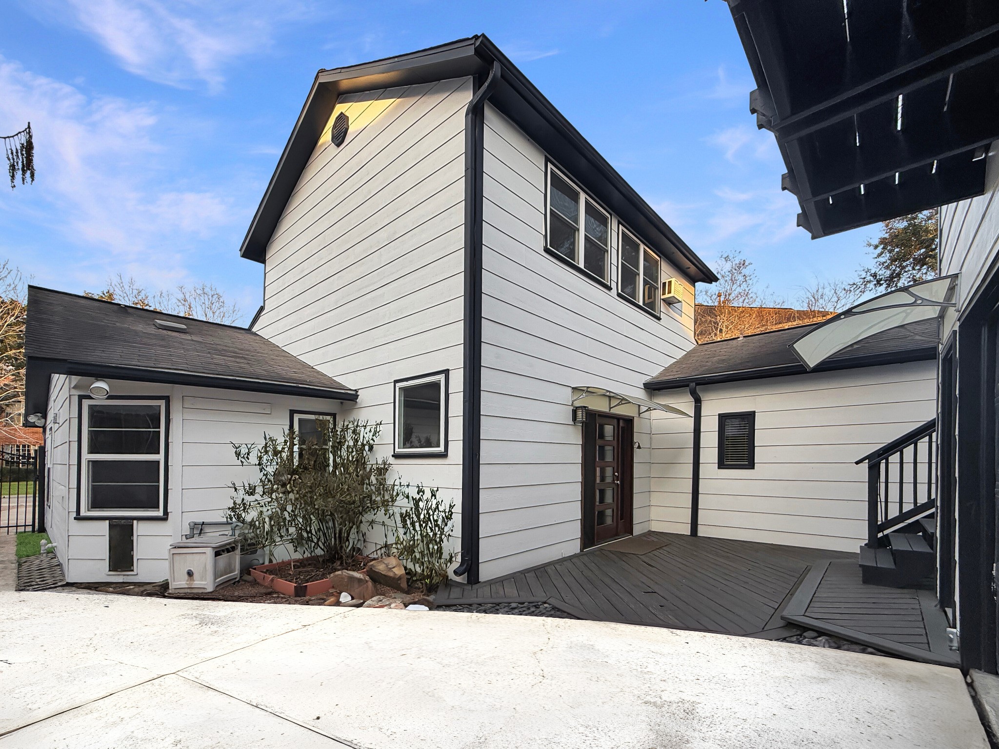 4521 Maple Street Bellaire, TX 77401 - Photo 34 of 36 Private driveway entrance leading to the detached garage apartment with modern black trim and clean architectural lines.